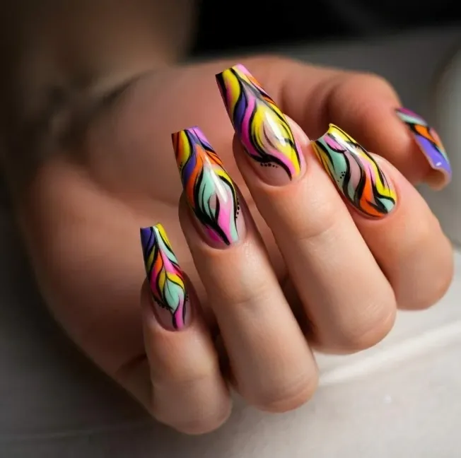 Colorful nail art with flowing rainbow patterns